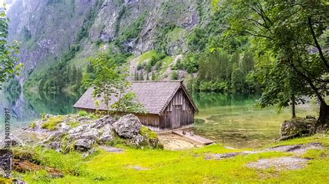 Romantic wooden boathouse at the lake Obersee next to lake Königssee in the Bavarian alps ...