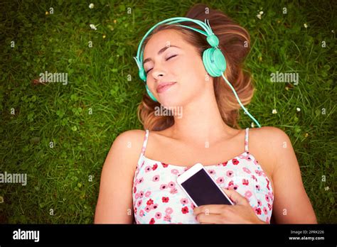 Young woman lying in the grass hi-res stock photography and images - Alamy