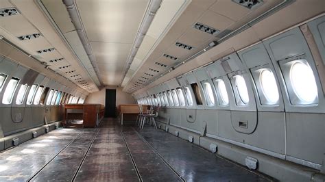 Inside the airplane. Empty interior of old airliner. Interior of aircraft without passenger ...