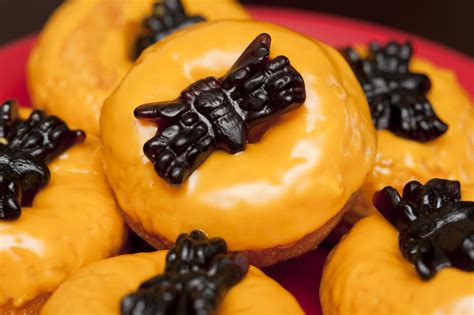 Image of Orange frosted doughnuts with jelly spiders | CreepyHalloweenImages