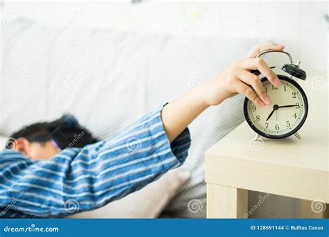 A Kids Waking Up To an Alarm Clock in the Bedroom Stock Photo - Image ...