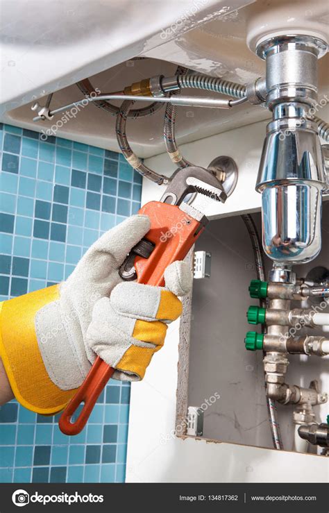 Repairing a pipe under sink. Plumber Stock Photo by ©bvb1981 134817362