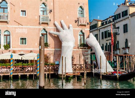 Giant hands sculpture rise from the water in Venice to highlight ...