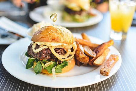 Royalty-Free photo: Beef burgers with homemade baked potatoes from above | PickPik