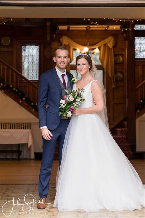 a bride and groom pose for a photo in front of the staircase at their ...