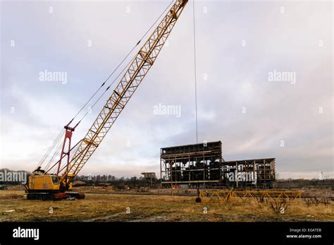 Crane with wrecking ball outside a semi-demolished power station Stock Photo - Alamy