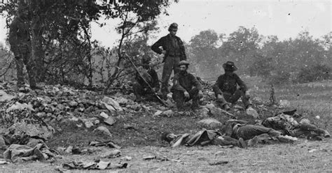 Union soldiers posing with dead Confederate troops who died during the ...