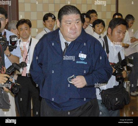 TOKYO, Japan - Takasago Stable elder Takasago looks nervous as he waits ...