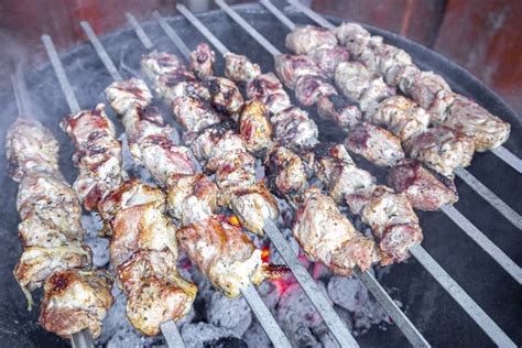 Russian Shashlik with Skewers on a Round Grill Stock Photo - Image of ...