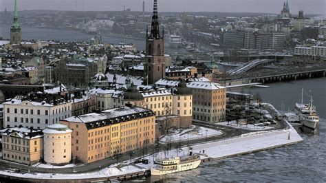 Download Snowy Stockholm Skyline In Winter Wallpaper | Wallpapers.com