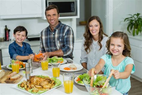 Family having lunch together on dining table — Stock Photo ...