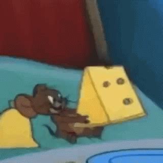 a cartoon mouse is playing with a block of cheese