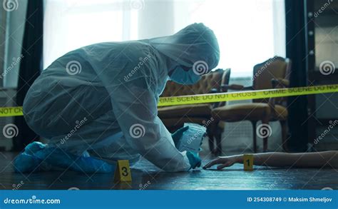 Detective Collecting Evidence in a Crime Scene. Forensic Specialists ...