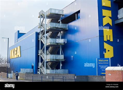 Ikea Ashton-under-Lyne store exterior copyspace yellow blue logo large walking past person ...