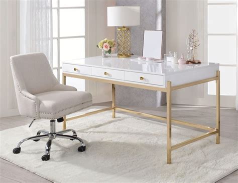 a white desk with a chair in front of it and a lamp on the side