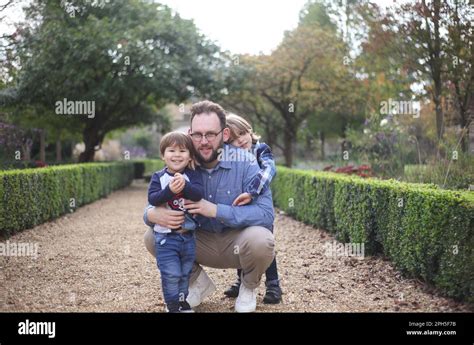 Happy family in beautiful garden Stock Photo - Alamy