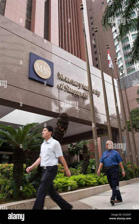 People walk past the the Monetary Authority of Singapore (MAS) building in Singapore Stock Photo ...