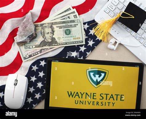 In this photo illustration, Wayne State University logo seen displayed on a tablet Stock Photo ...