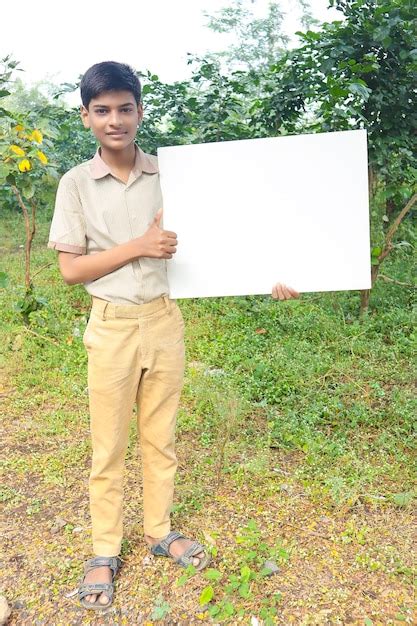 Premium Photo | Indian boy in school uniform and showing cardboard