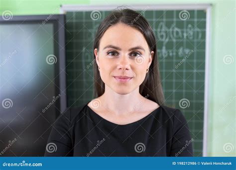 Close-up Face of Young Female Teacher Near Chalkboard and Digital ...