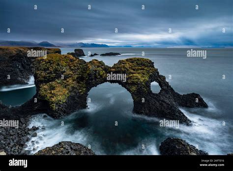 Gatklettur at sunrise, rock arch in the sea, Arnarstapi, Snäfellsnes Peninsula, West Iceland ...