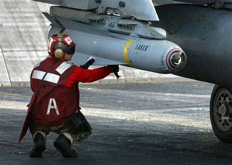 Aviation Ordnanceman 3rd Class William Miller arms a AGM-65 Maverick laser-guided missile [2100 ...