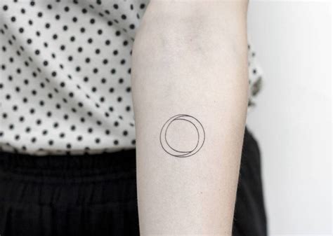 Hand poked minimalist circle tattoo on the left inner