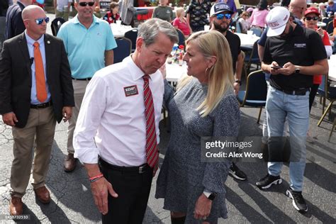 Gov. Brian Kemp listens to his wife Marty Kemp during a campaign stop ...