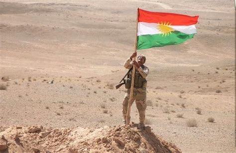 A proud Peshmerga stands under Kurdistan Flag | Peshmerga, Kurdistan ...