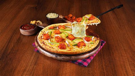 Order Schezwan Paneer Cheese Burst Pizza Medium from Ovenstory on EatSure