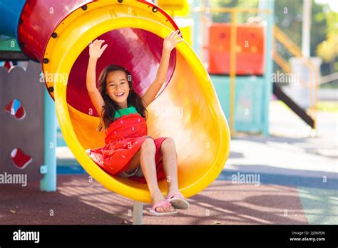 Kids on playground. Children play outdoor on school yard slide. Healthy ...