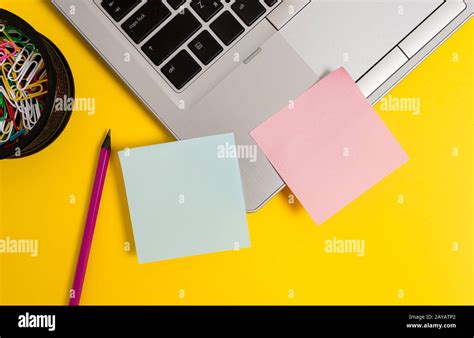 Front view open trendy metallic silver slim laptop blank sticky notes pencil clips container ...