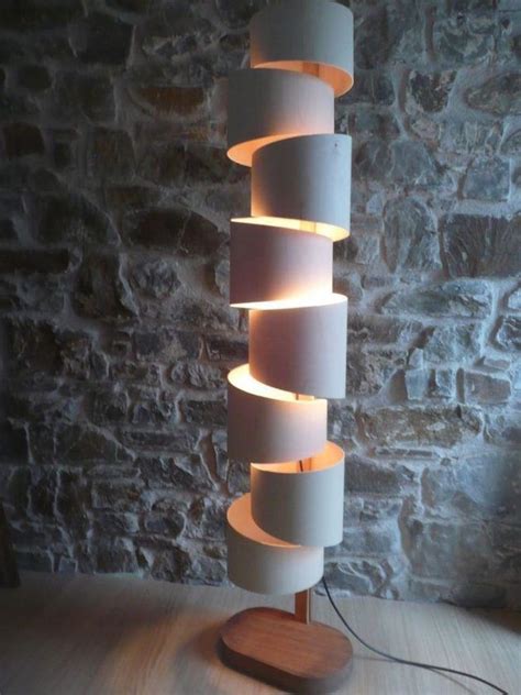 a lamp that is sitting on top of a wooden table next to a brick wall