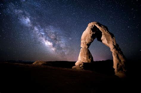 a rock formation with the milky in the background and a quote from j t ...