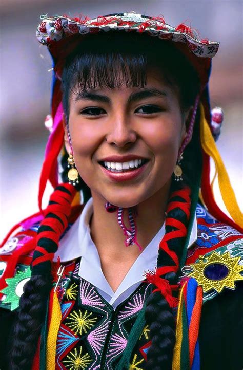 a woman in colorful clothing smiles for the camera while wearing an ...