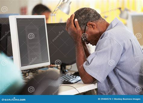 Stressed Man Working at Desk in Busy Creative Office Stock Photo - Image of indoors, computer ...