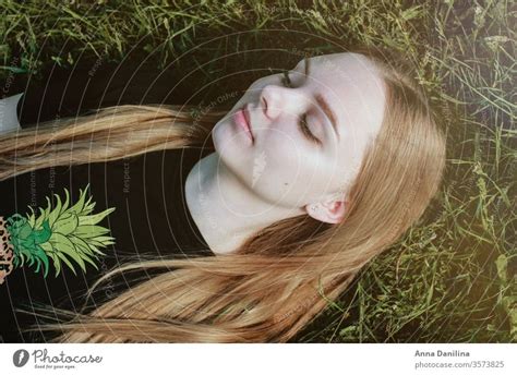 Pretty girl laying in the grass - a Royalty Free Stock Photo from Photocase