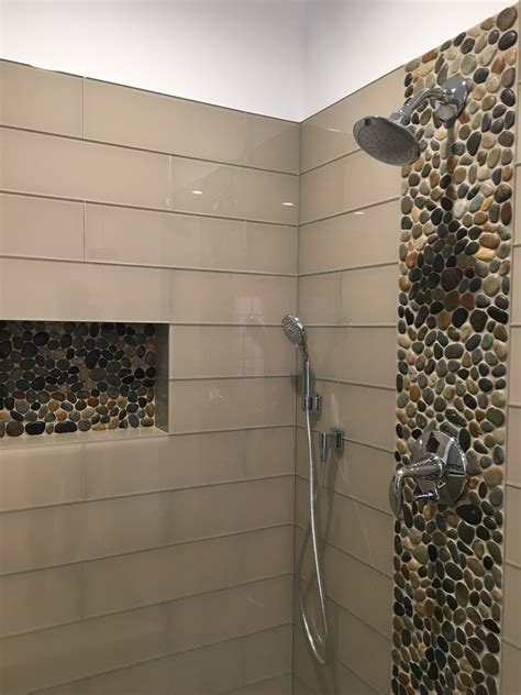 Stunning accent strip and niche using Glazed Bali Ocean Pebble Tile. https://www.pebbletileshop ...