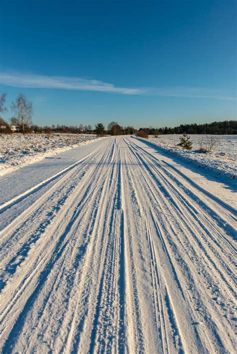 Snow Covered Winter Road with Tire Tracks Stock Photo - Image of cold ...