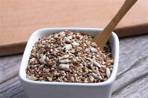 Premium Photo | Closeup of a bowl with seed mixture and utensils in the ...