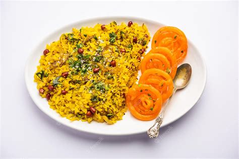 Premium Photo | Aloo poha with jalebi snack combination also called ...