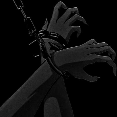 a person with their hands chained to a pole in the dark, holding onto chains