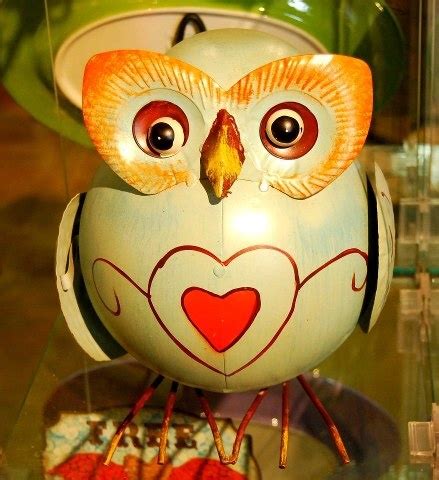 an owl figurine sitting on top of a glass table