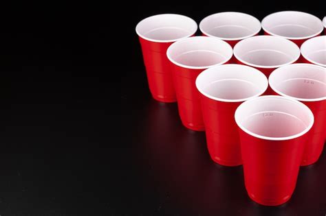 Premium Photo | Red plastic cups and ball for game of beer pong