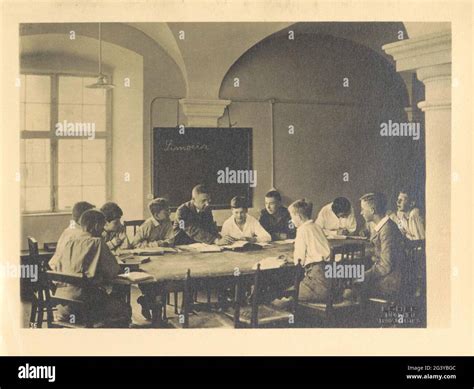 Teacher with students in a classroom from Schule Schloss Salem. Part of photo album from Schule ...