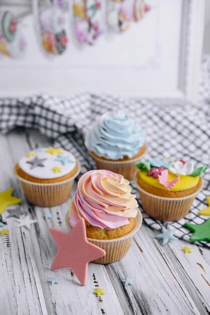 Premium Photo | Multiple colorful nicely decorated muffins on a wooden ...