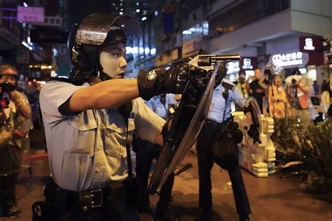 The Latest: Hong Kong police confirm warning shot, arrest 36