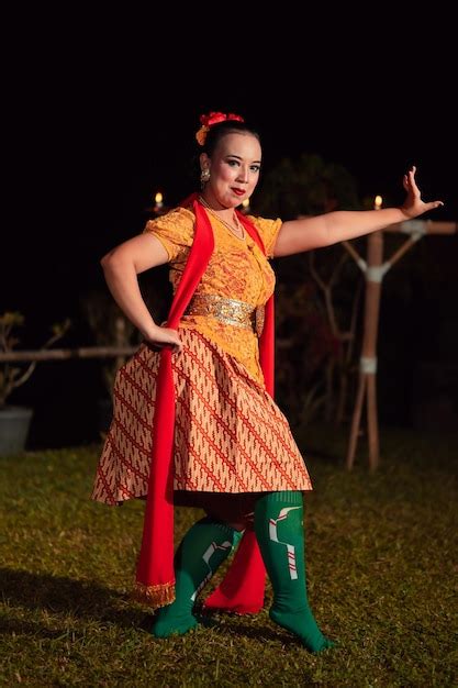 Premium Photo | Balinese dancer with an orange costume and wearing ...