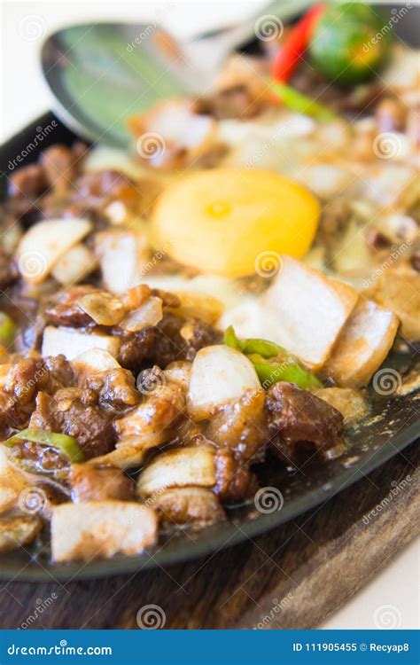 Sizzling Pork Sisig with Raw Egg Stock Image - Image of pepper, calamondin: 111905455