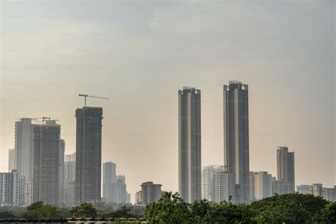 A city skyline with tall buildings and a crane photo – India Image on Unsplash